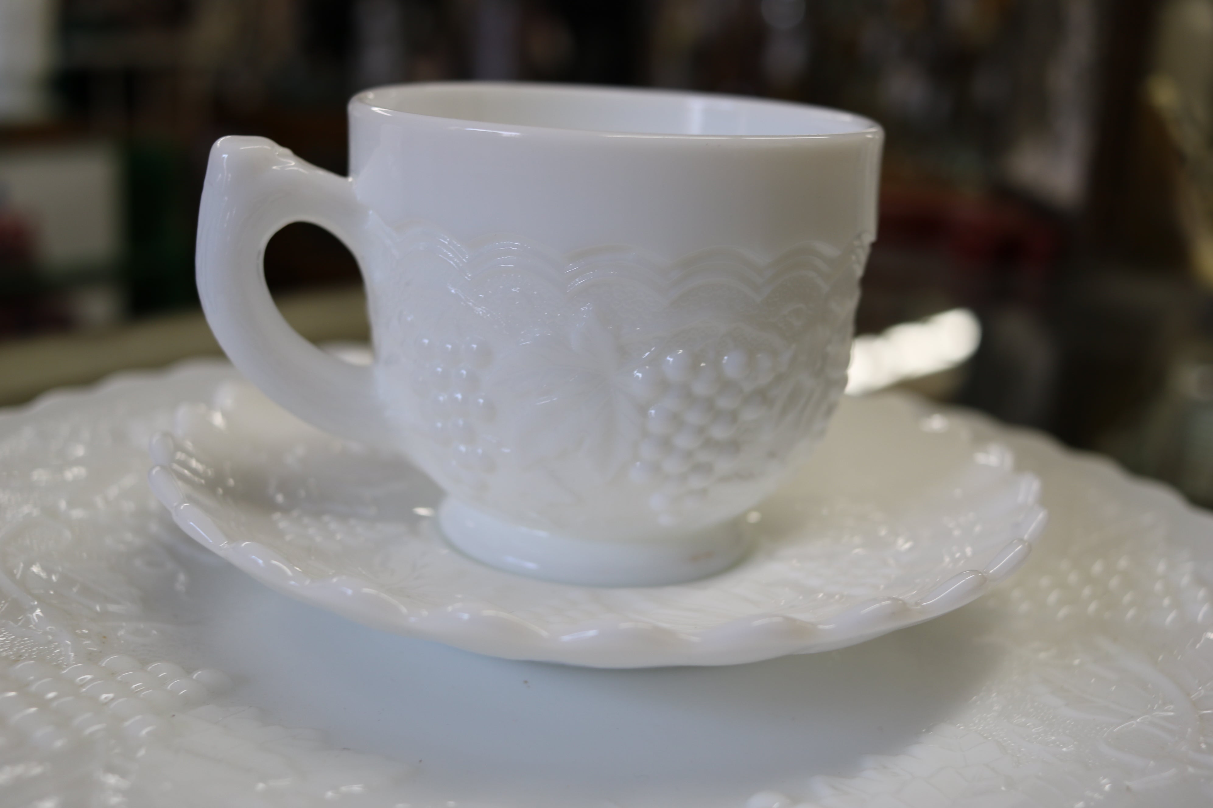 https://www.twovintagesisters.com/cdn/shop/products/Imperial-milk-glass-white-grape-pattern-plate-cups_1.jpg?v=1619661880