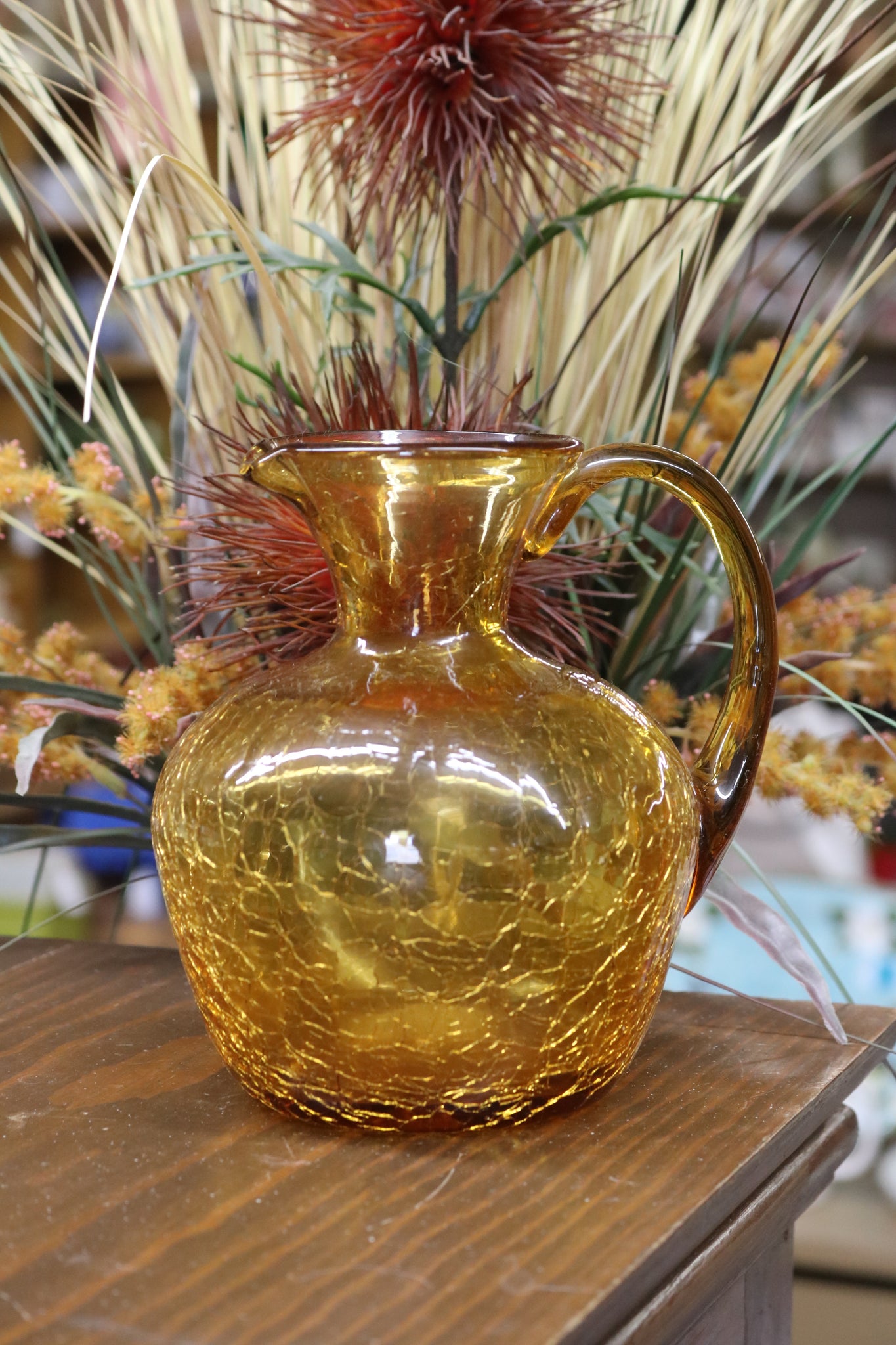 A Small Clear Crackled Amber Hand Blown Glass Pitcher With a