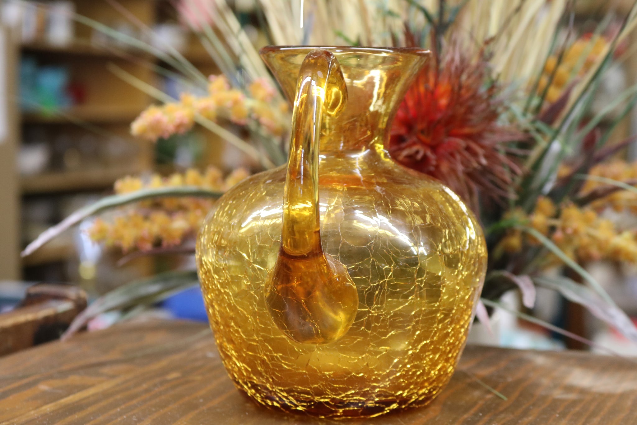 A Small Clear Hand Blown Glass Amber Glass Pitcher With a Pinched Spout and  a Clear Stretched Applied Glass Handle. Misc 862 